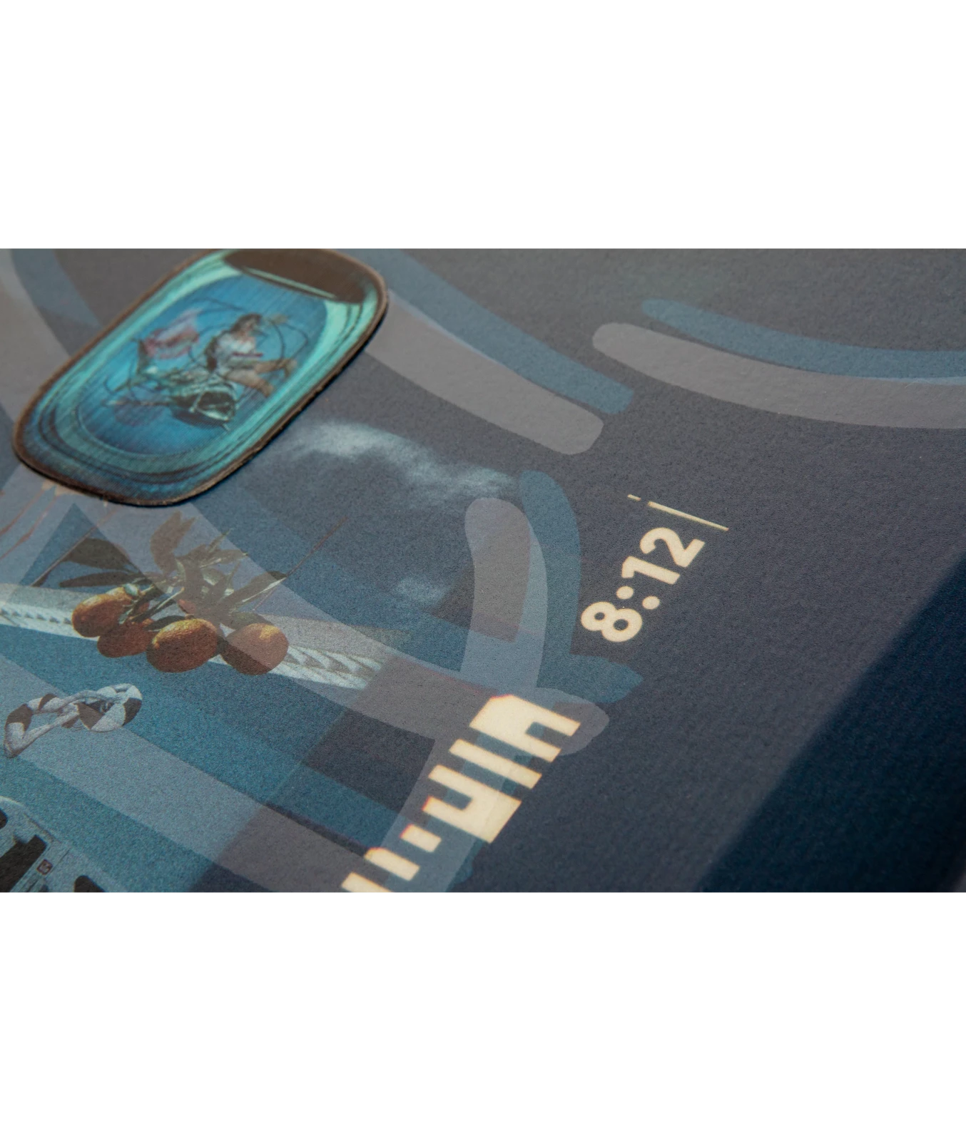Ronix Supreme wakeboard graphic, top inset image of 8:12, showing the corner of the lenticular badge.