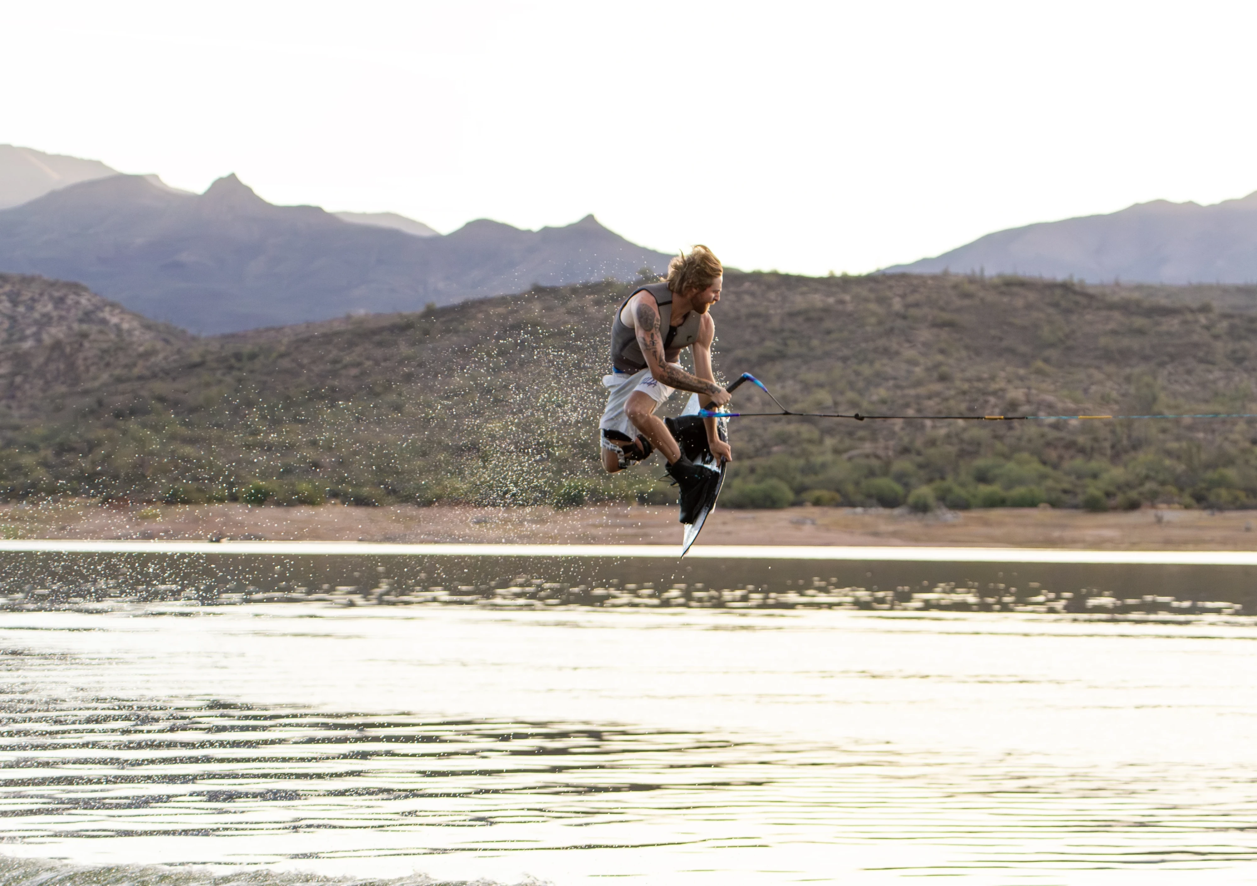 Action shot of Massi Piffaretti riding the Ronix RXT - Ronix Xperiemental Technology, with water in the background