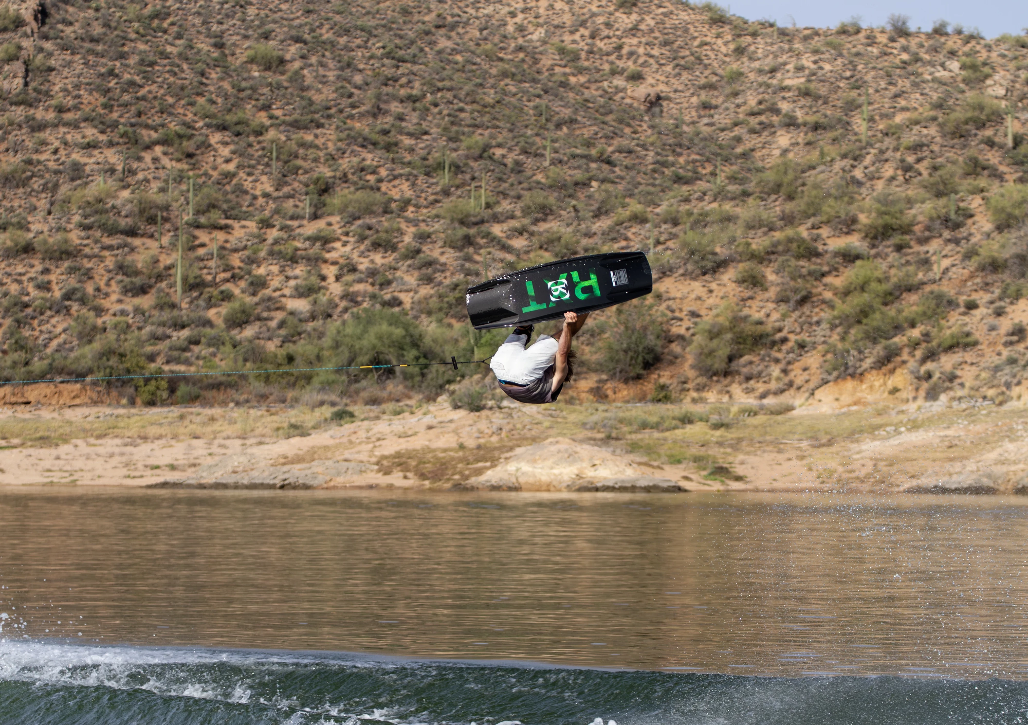 Action shot of Massi Piffaretti riding the Ronix RXT - Ronix Xperiemental Technology, with water in the background