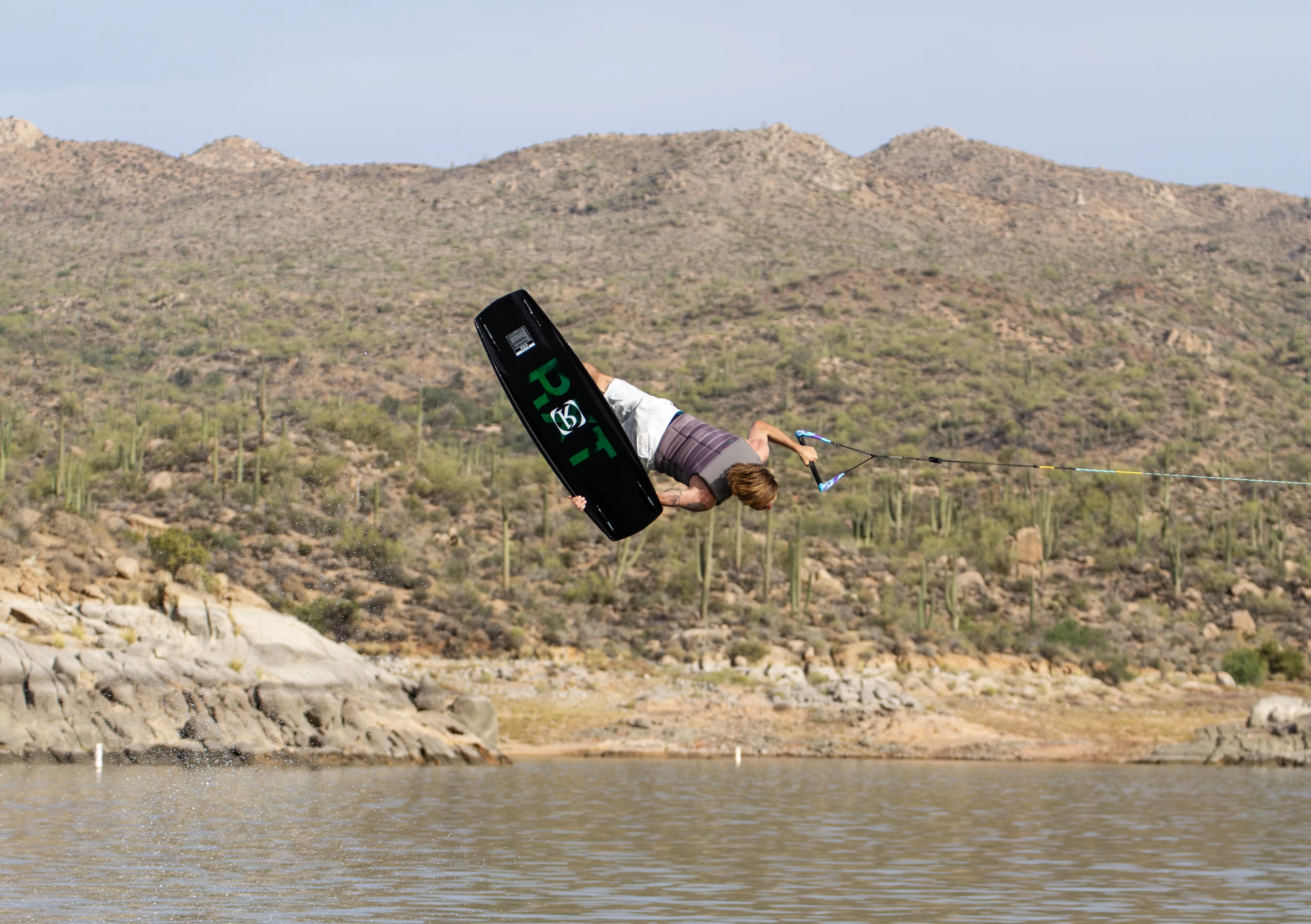 Action shot of Massi Piffaretti riding the Ronix RXT - Ronix Xperiemental Technology, with water in the background